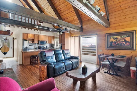 a kitchen with stainless steel appliances granite countertop a sink dishwasher a stove a refrigerator and cabinets with wooden floor