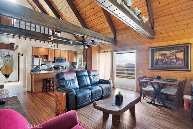 a kitchen with stainless steel appliances granite countertop a sink dishwasher a stove a refrigerator and cabinets with wooden floor