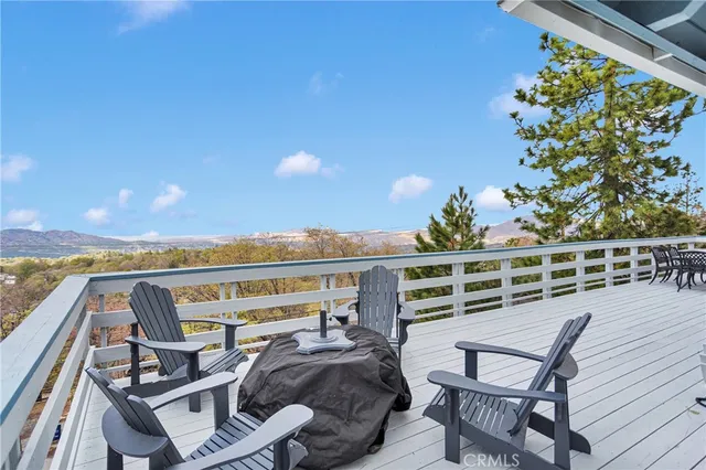 a view of a chairs and table on the wooden deck