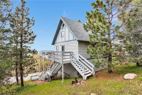 a bedroom with furniture and a wooden floor