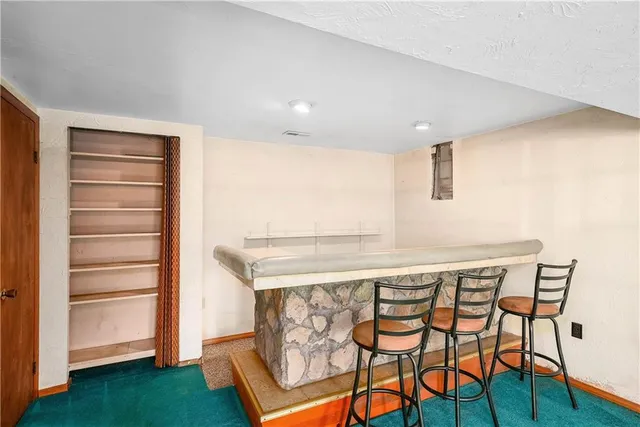 a kitchen with a table and chairs