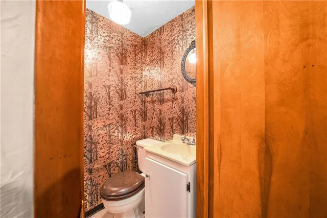 a bathroom with a toilet and a shower curtain