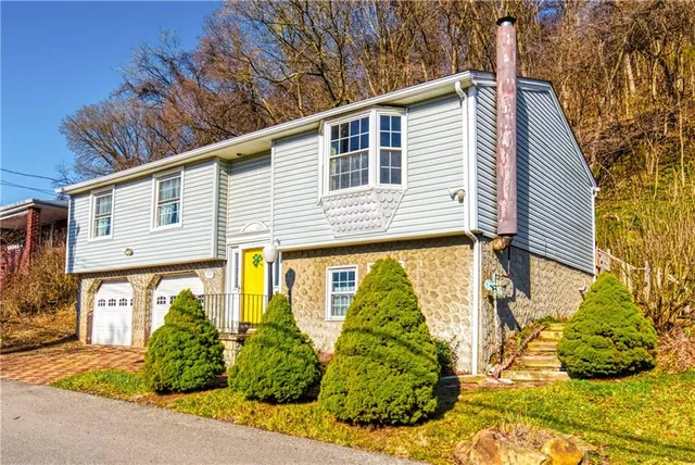 a front view of a house with a yard