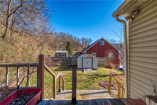 a view of a house with a small yard and wooden fence