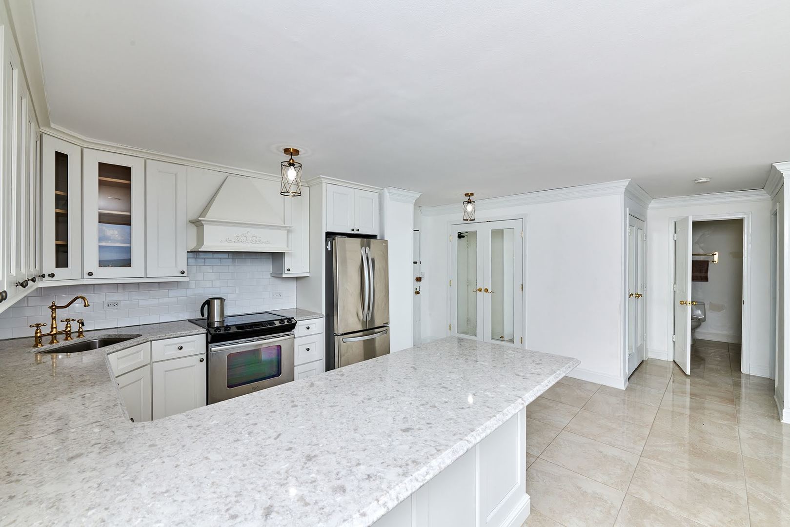 5455 North Sheridan Road, Unit 3811 Chicago, IL 60640 - Photo 11 of 35 a kitchen with stainless steel appliances granite countertop a sink and refrigerator