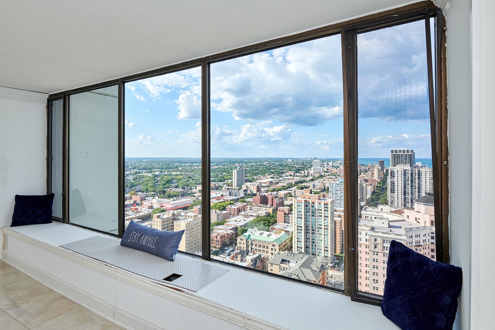 5455 North Sheridan Road, Unit 3811 Chicago, IL 60640 - Photo 12 of 35 a living room with large windows and a table