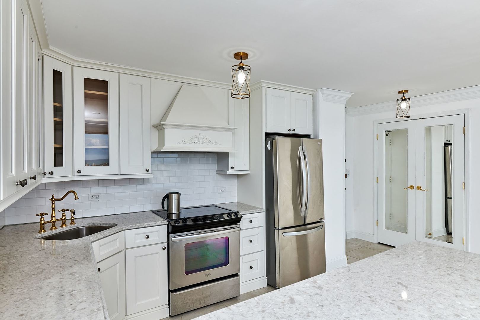 5455 North Sheridan Road, Unit 3811 Chicago, IL 60640 - Photo 13 of 35 a kitchen with stainless steel appliances granite countertop a refrigerator sink and stove