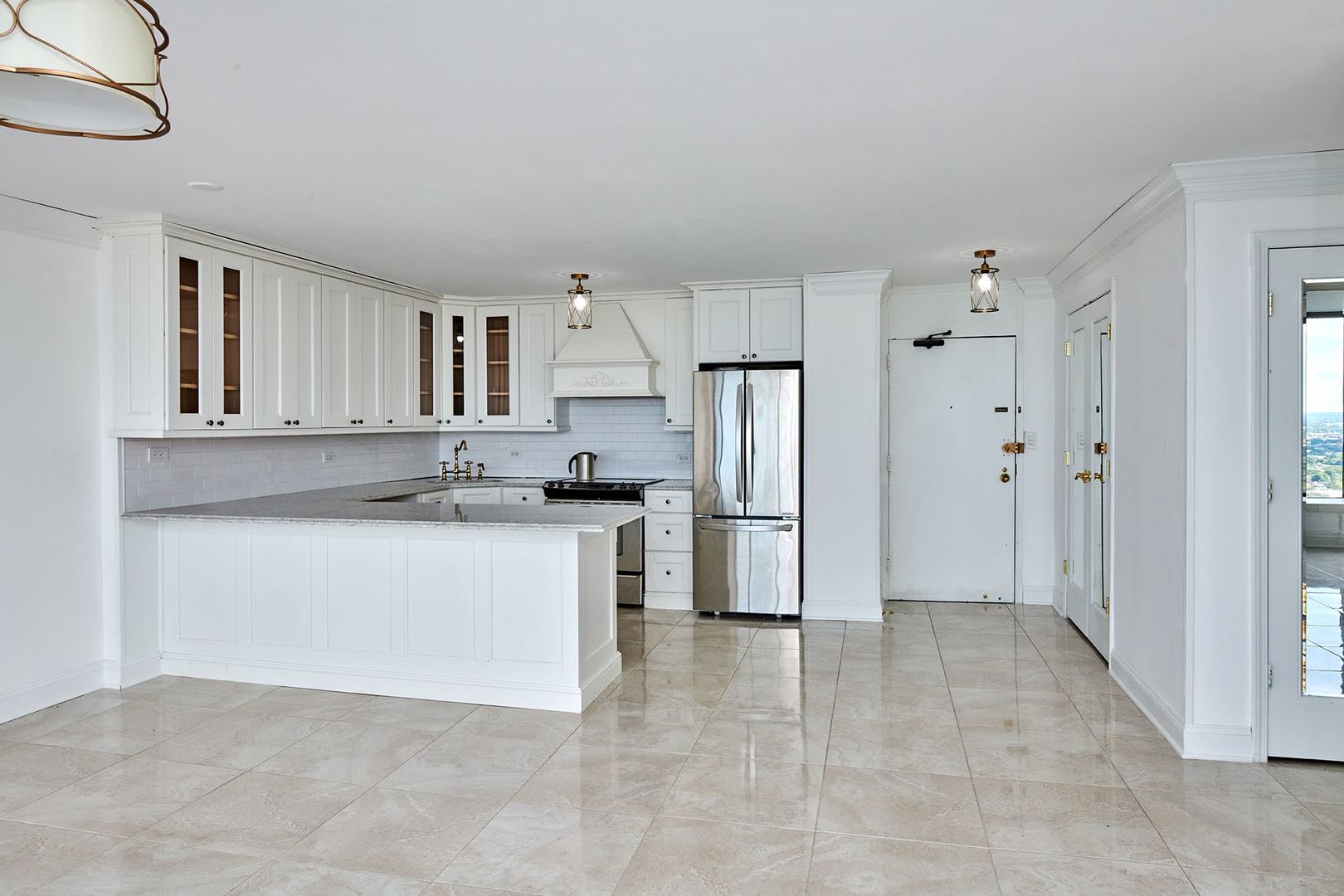 5455 North Sheridan Road, Unit 3811 Chicago, IL 60640 - Photo 14 of 35 a kitchen with a refrigerator sink and cabinets