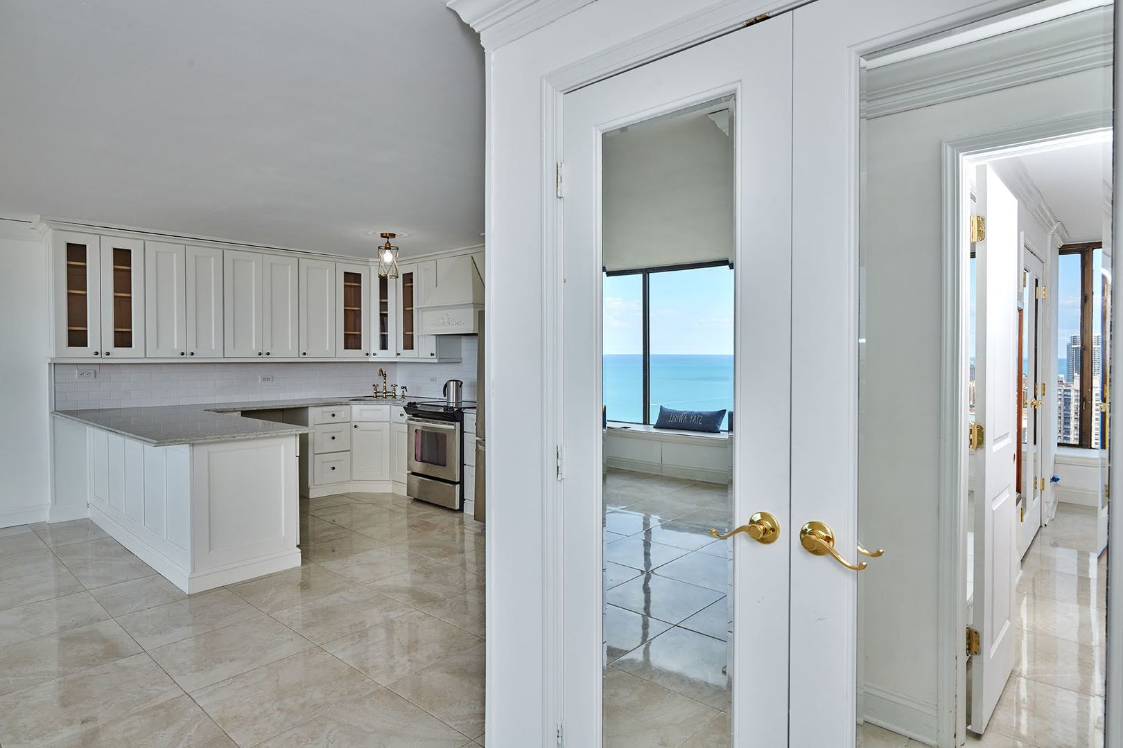 5455 North Sheridan Road, Unit 3811 Chicago, IL 60640 - Photo 15 of 35 a kitchen with a refrigerator and white cabinets