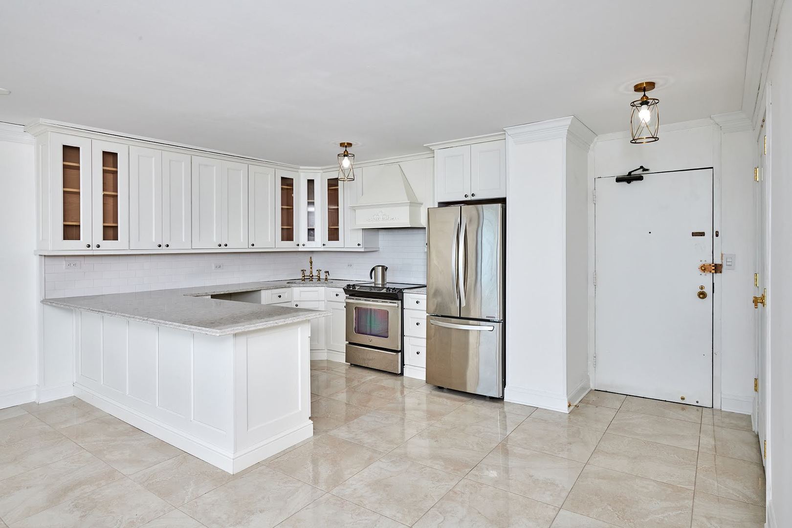 5455 North Sheridan Road, Unit 3811 Chicago, IL 60640 - Photo 18 of 35 a kitchen with a stove a refrigerator and a sink