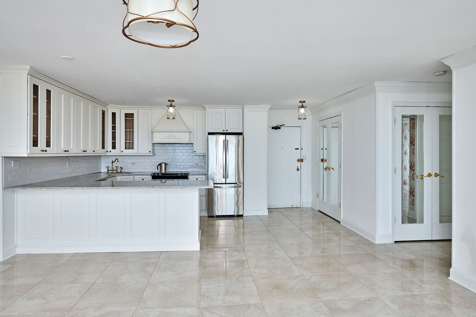 5455 North Sheridan Road, Unit 3811 Chicago, IL 60640 - Photo 3 of 35 a large kitchen with cabinets and stainless steel appliances