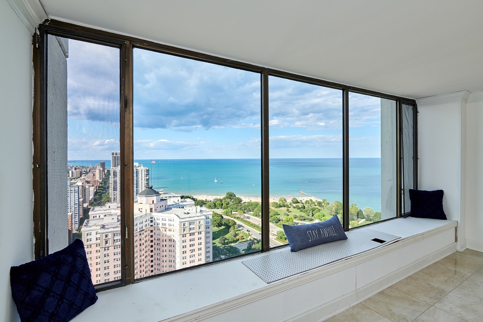 5455 North Sheridan Road, Unit 3811 Chicago, IL 60640 - Photo 5 of 35 a living room with large windows and a couch