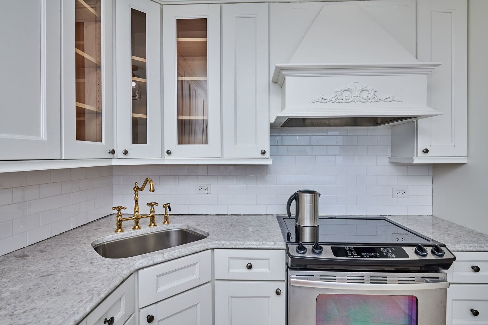 5455 North Sheridan Road, Unit 3811 Chicago, IL 60640 - Photo 7 of 35 a kitchen with granite countertop white cabinets and a stove