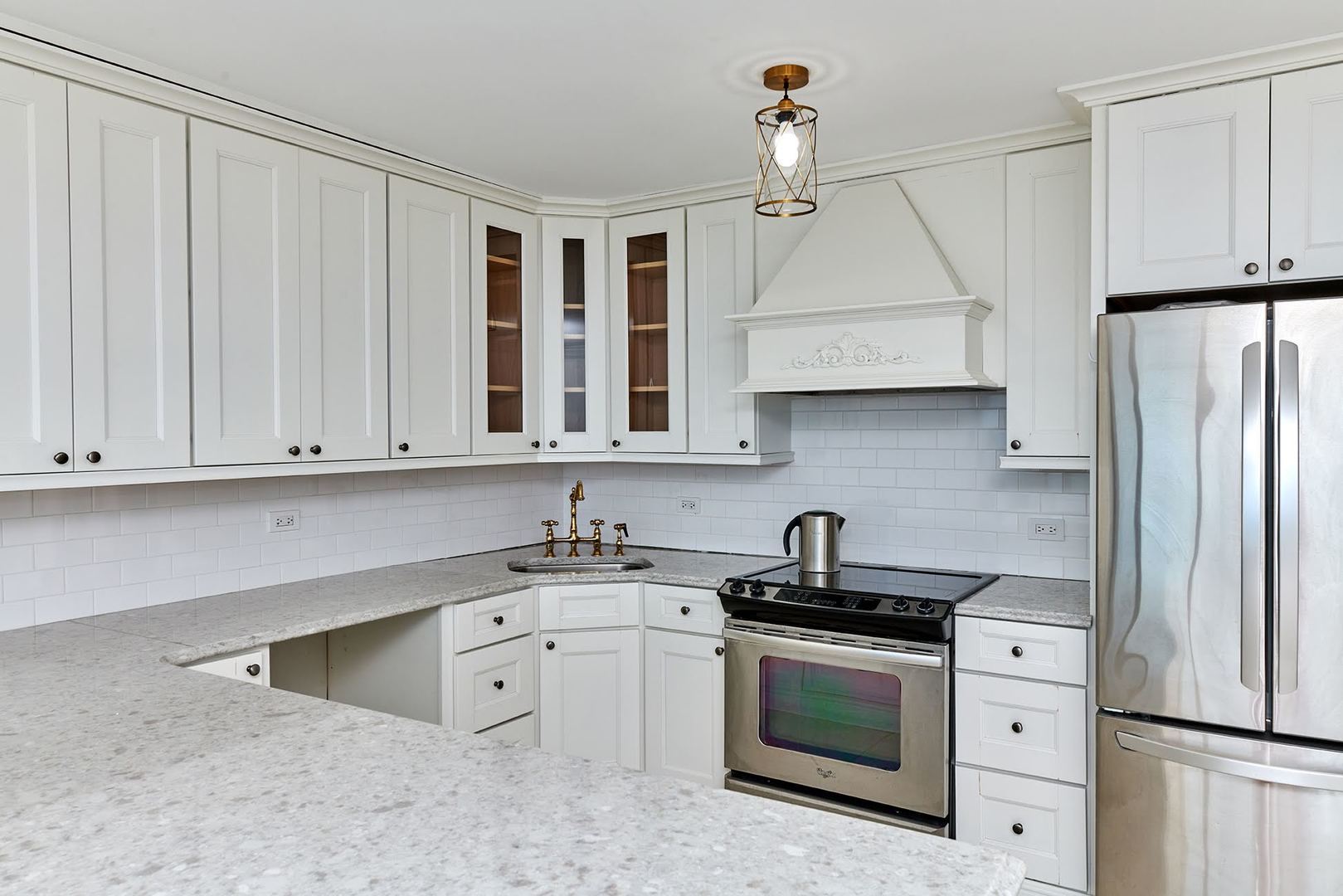 5455 North Sheridan Road, Unit 3811 Chicago, IL 60640 - Photo 8 of 35 a kitchen with white cabinets and white appliances