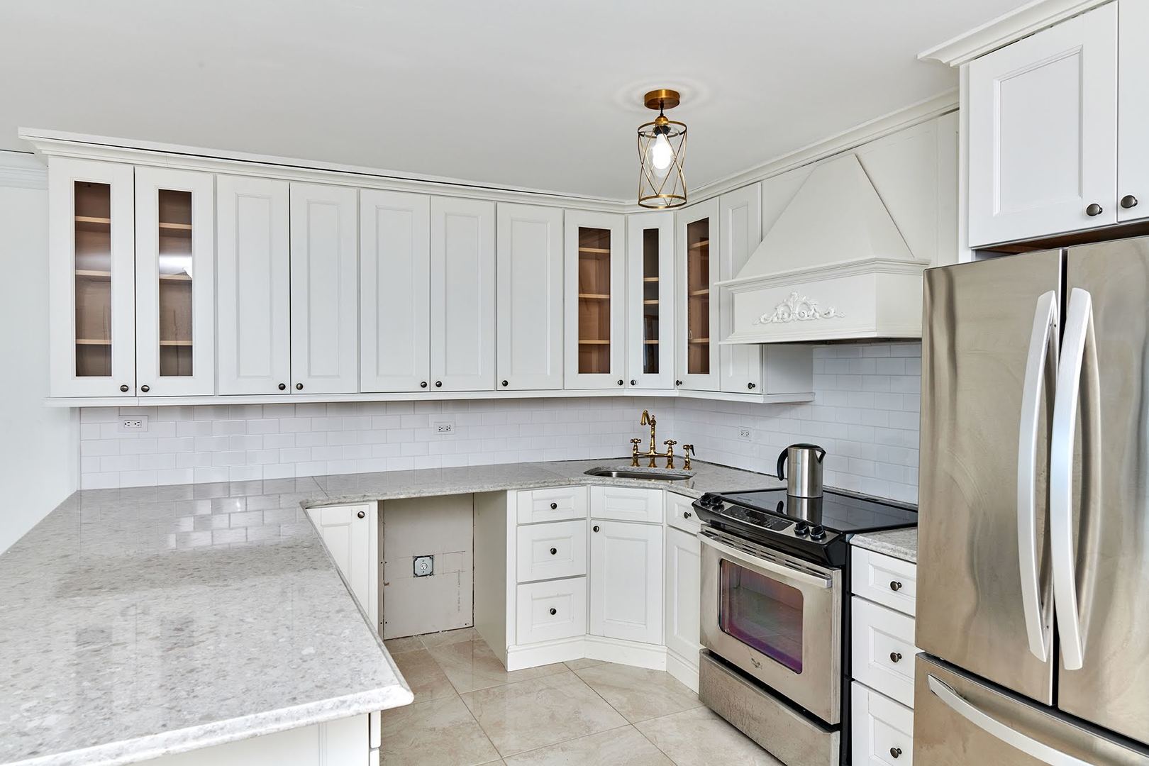 5455 North Sheridan Road, Unit 3811 Chicago, IL 60640 - Photo 10 of 35 a kitchen with stainless steel appliances granite countertop a sink a stove and a refrigerator