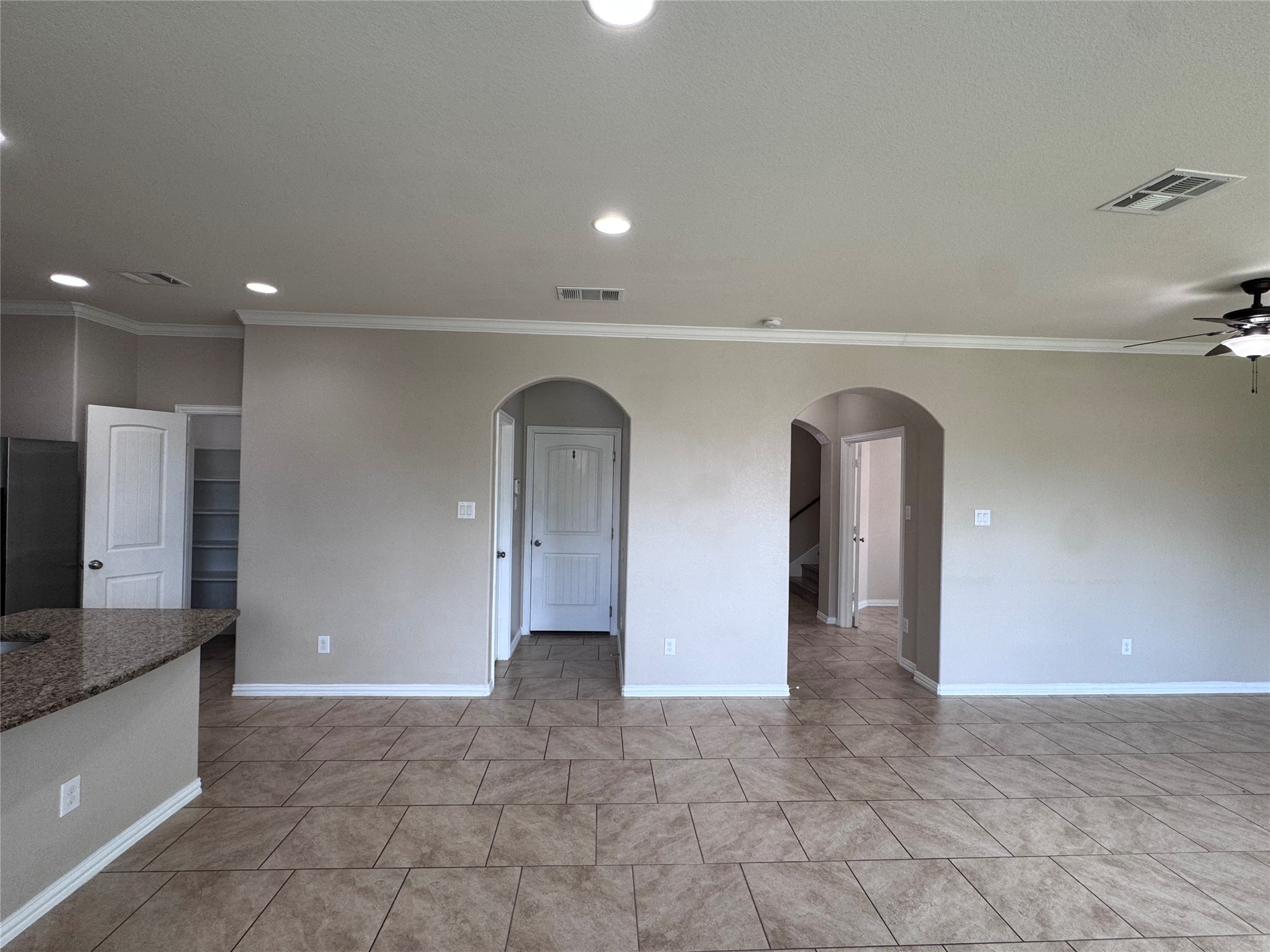 2605 Rough Berry Road Pflugerville, TX 78660 - Photo 15 of 40 Arched doorways and high ceilings define this open-concept living space, featuring durable tile flooring.