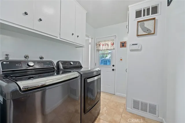 a kitchen with stainless steel appliances kitchen island granite countertop a refrigerator and a sink
