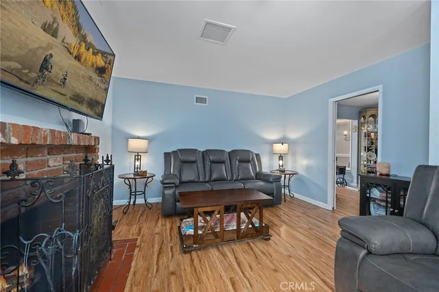 a living room with fireplace furniture and a flat screen tv