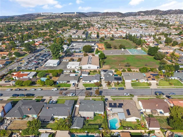 an aerial view of a house with a swimming pool yard and mountain view in back