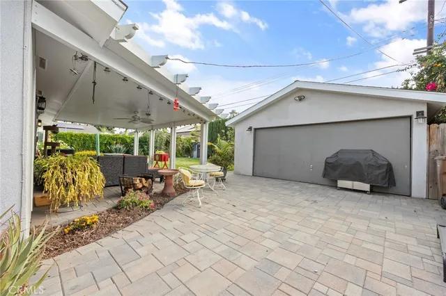 a view of a porch with furniture and floor to ceiling window