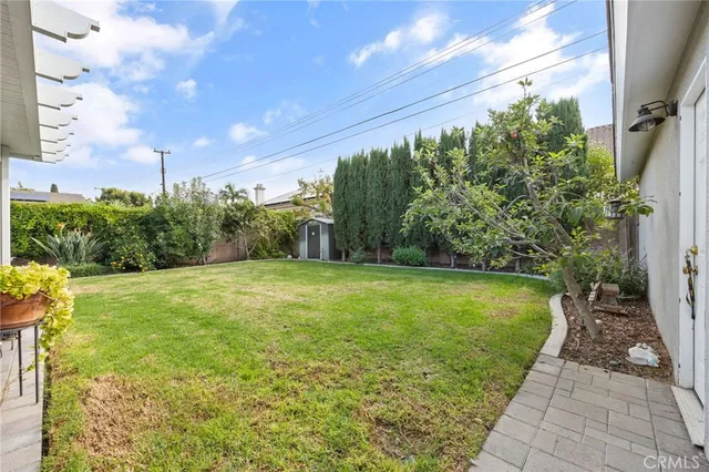 a view of a yard with potted plants