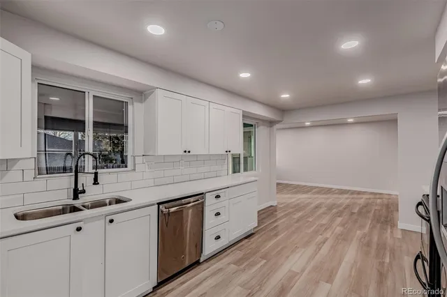 a kitchen with sink and cabinets