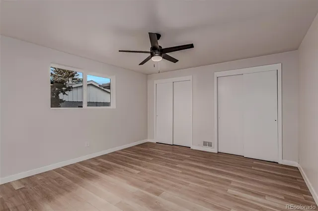 a view of empty room with wooden floor