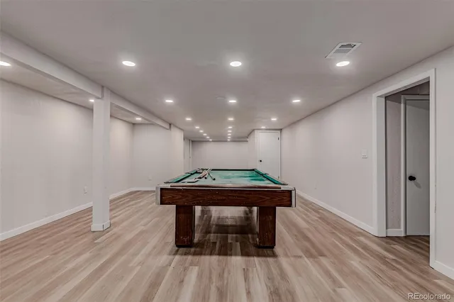 a room with wooden floor and furniture