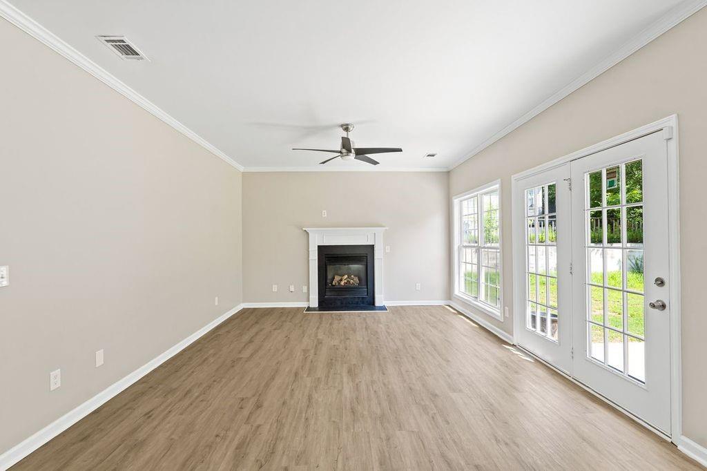 473 Greyhawk Way Fairburn, GA 30213 - Photo 12 of 34 a view of an empty room with a window and wooden floor
