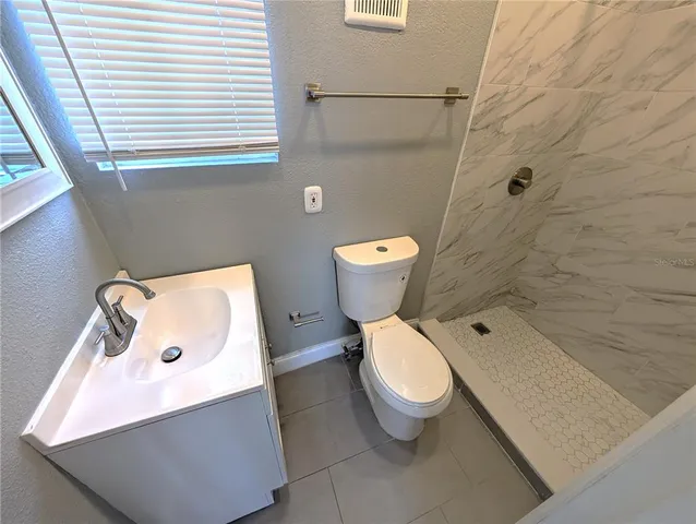 a white toilet sitting next to a bathroom sink