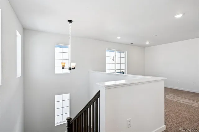 a utility room with closet and windows