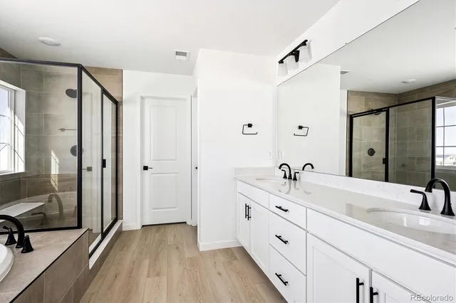 a spacious bathroom with a double vanity sink and a mirror