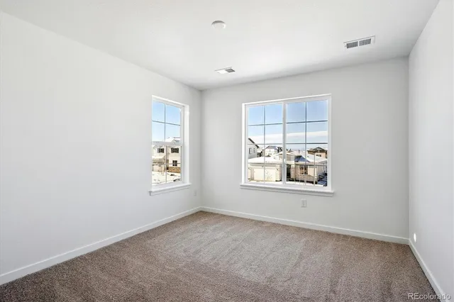 an empty room with windows and closet