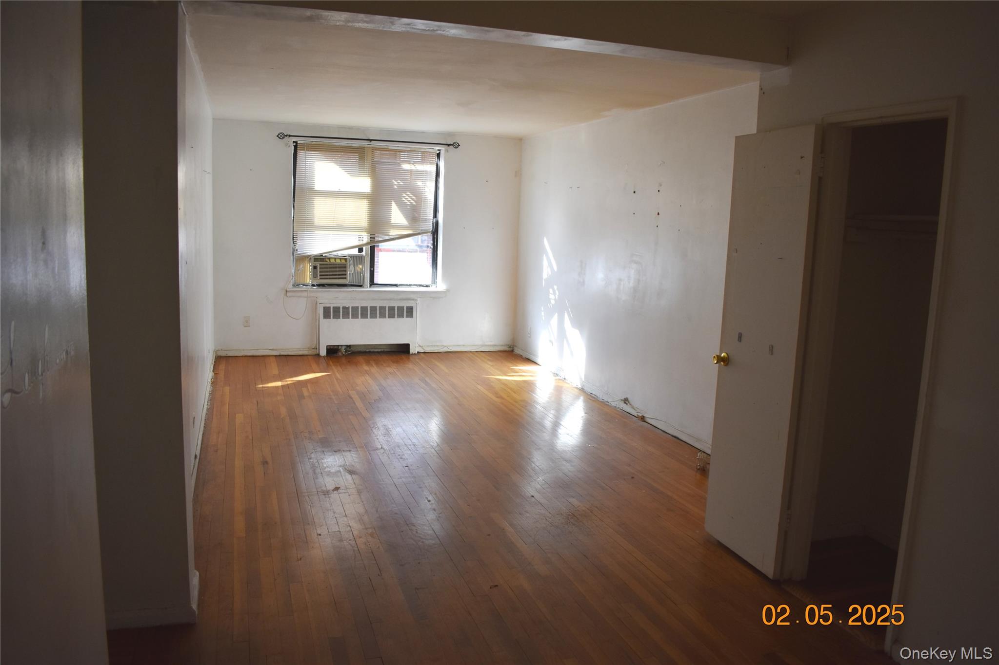 730 East 232nd Street, Unit 3G Bronx, NY 10466 - Photo 8 of 8 Spare room featuring radiator and hardwood / wood-style floors