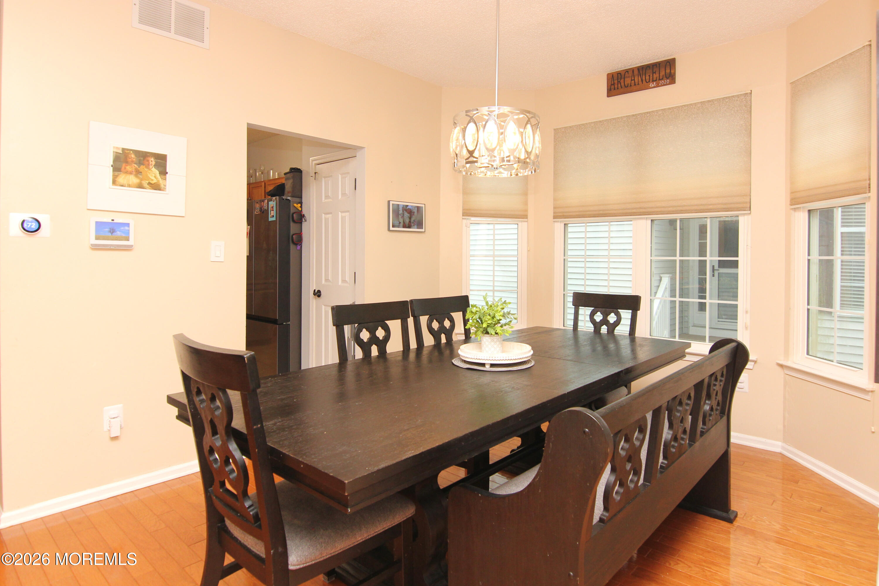 33 Austin Street Tinton Falls, NJ 07712 - Photo 37 of 46 a view of a dining room with furniture a chandelier and wooden floor