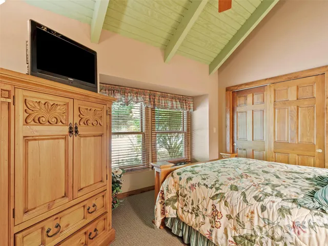 a bedroom with a large bed and tv