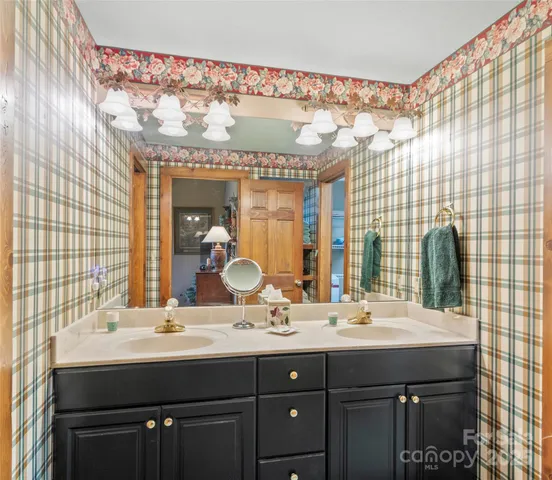 a bathroom with a double vanity sink and a mirror