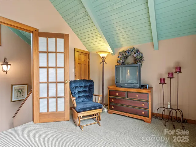 a living room with furniture a flat screen tv and a window