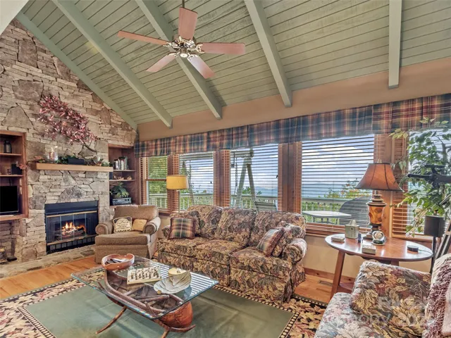 a living room with furniture fireplace and a large window