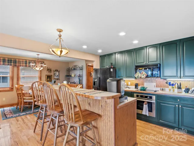 a kitchen with stainless steel appliances kitchen island granite countertop a sink and cabinets