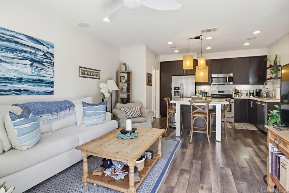 2182 Cosmo Way San Marcos, CA 92078 - Photo 16 of 34 a living room with kitchen island furniture and a wooden floor