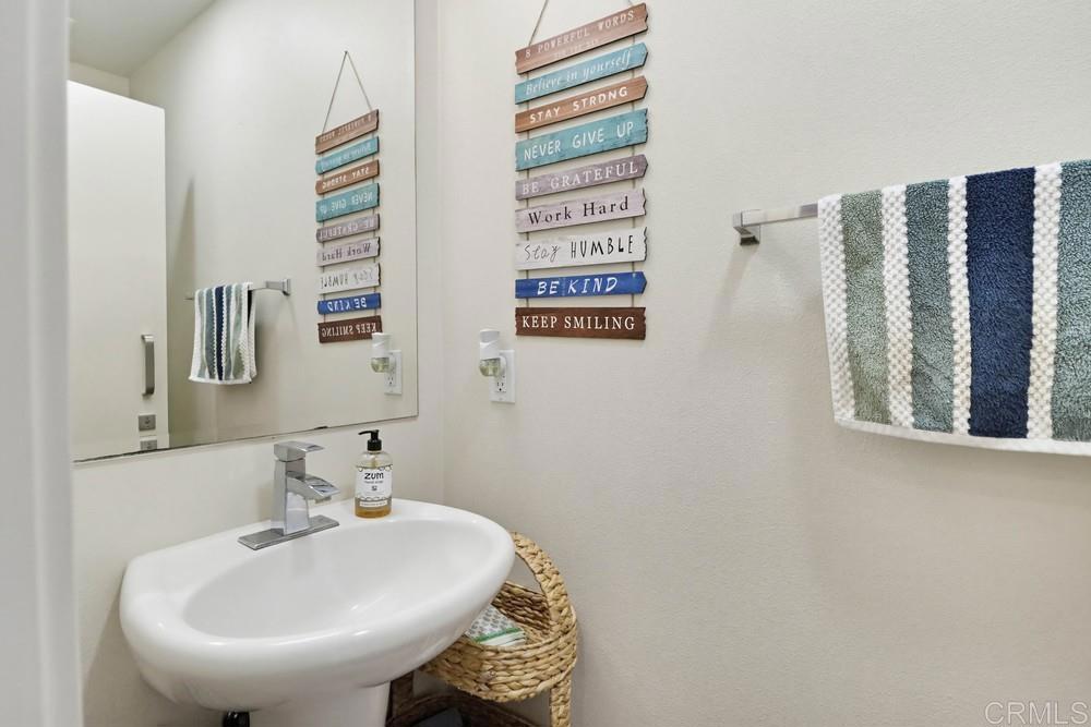2182 Cosmo Way San Marcos, CA 92078 - Photo 24 of 34 a bathroom with a sink and a mirror