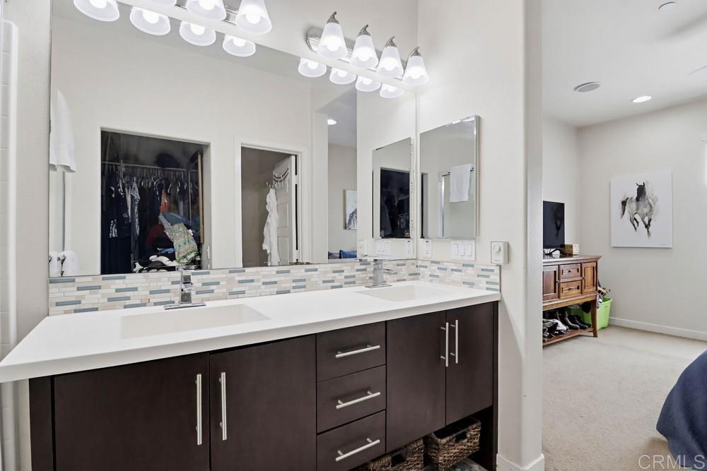 2182 Cosmo Way San Marcos, CA 92078 - Photo 28 of 34 a bathroom with a sink double vanity and a mirror