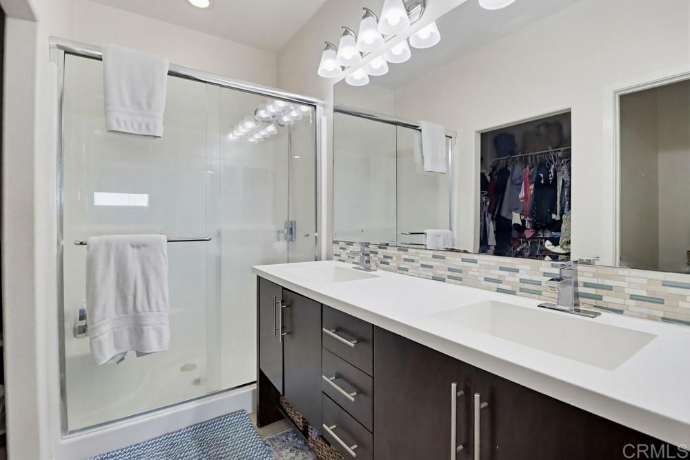2182 Cosmo Way San Marcos, CA 92078 - Photo 29 of 34 a bathroom with a double vanity sink mirror and shower