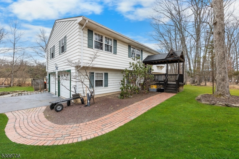 a view of a house with backyard porch and sitting area