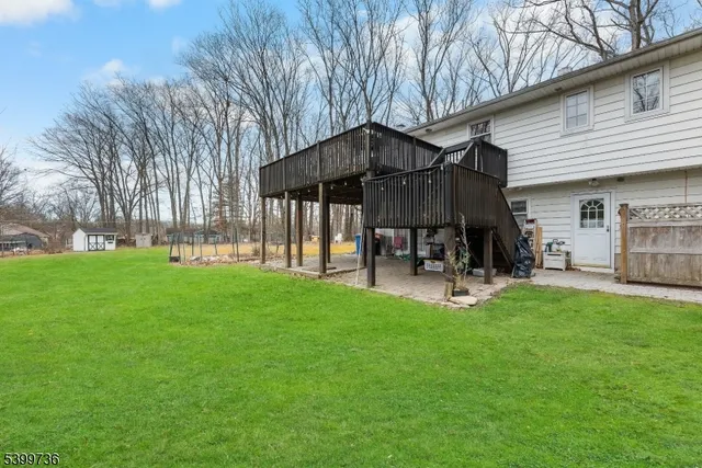a view of a backyard with table and chairs under an umbrella