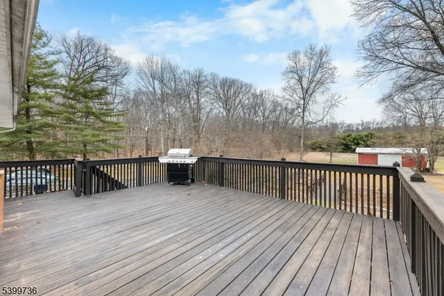 a view of a balcony with wooden floor and fence