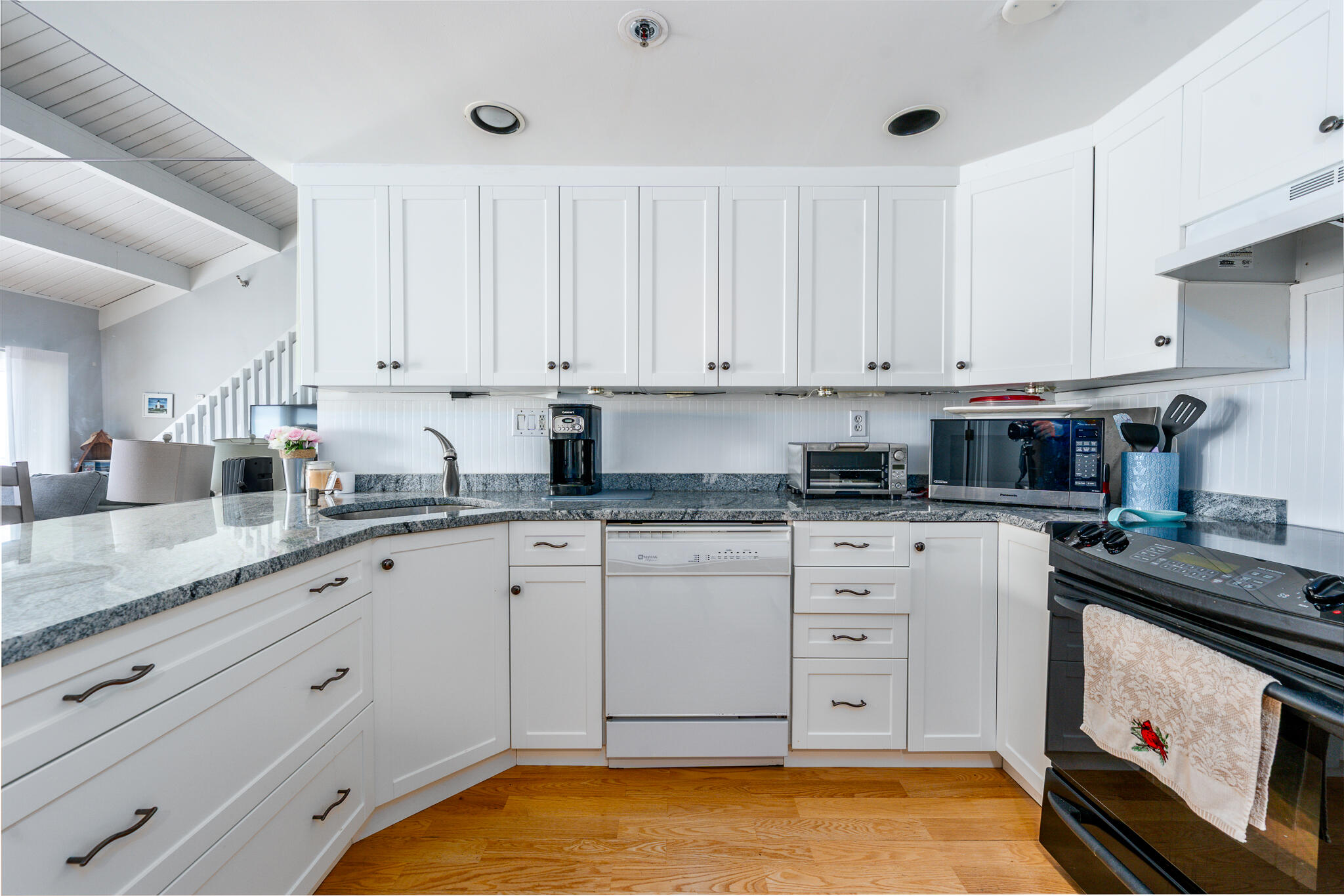94 Shore Drive West, Unit 9B Mashpee, MA 02649 - Photo 12 of 35 a kitchen with granite countertop white cabinets and white appliances