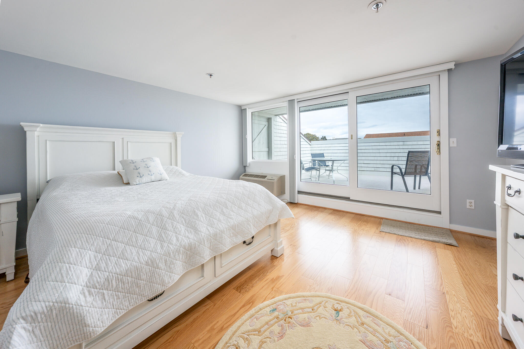 94 Shore Drive West, Unit 9B Mashpee, MA 02649 - Photo 15 of 35 a bedroom with a large bed and a large window with outer view