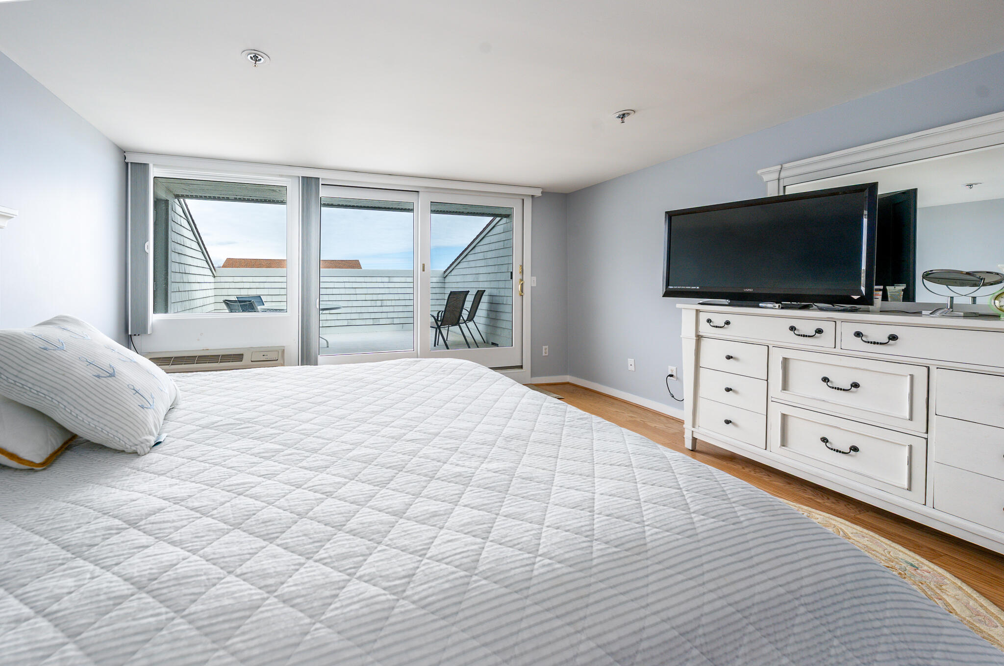 94 Shore Drive West, Unit 9B Mashpee, MA 02649 - Photo 16 of 35 a bedroom with a bed and a flat screen tv